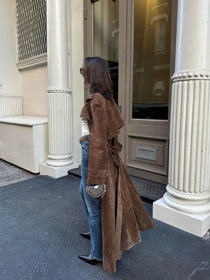 Women's brown full-length trench coat with contrast lapels and waist belt