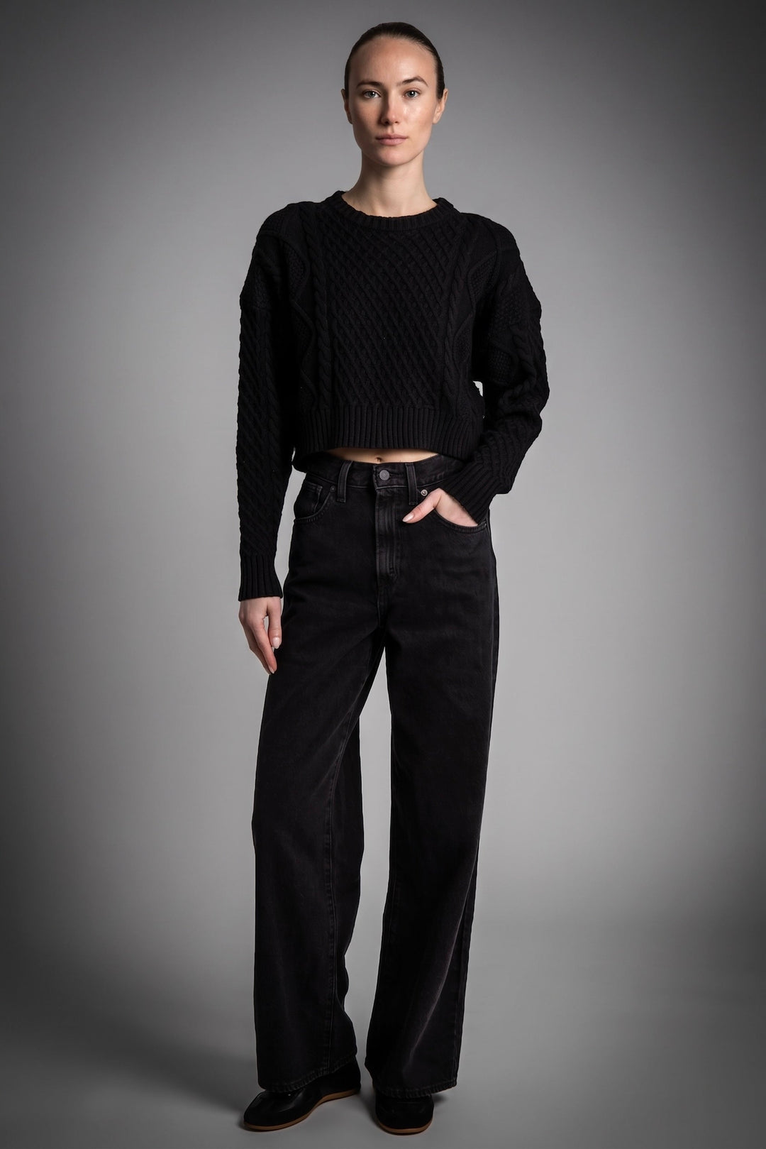 Women's cropped cable knit sweater with crew neckline and long sleeves
