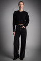 Women's cropped cable knit sweater with crew neckline and long sleeves