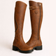 Women's knee-high boots with buckle strap, side zipper and lug sole