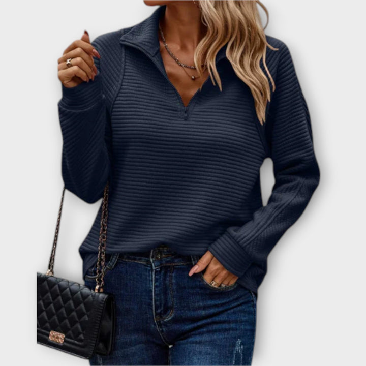 Women's ribbed knit sweater with raised collar and zip neck