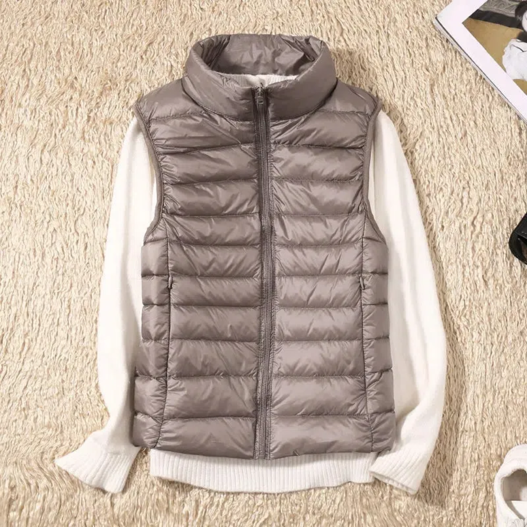 Women's sleeveless quilted puffer vest with raised collar and front zip