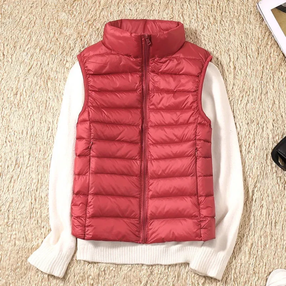 Women's sleeveless quilted puffer vest with raised collar and front zip