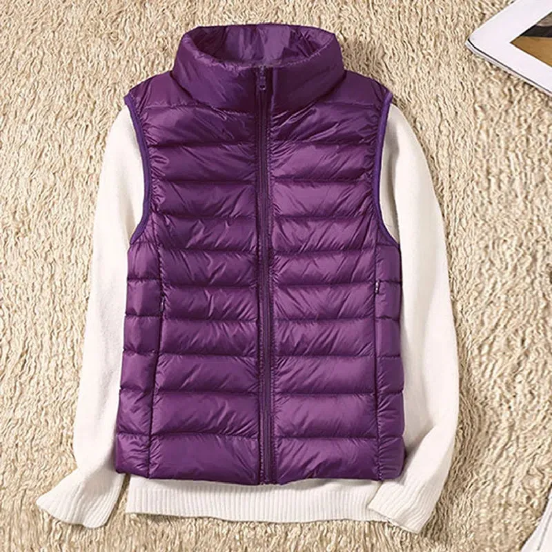 Women's sleeveless quilted puffer vest with raised collar and front zip