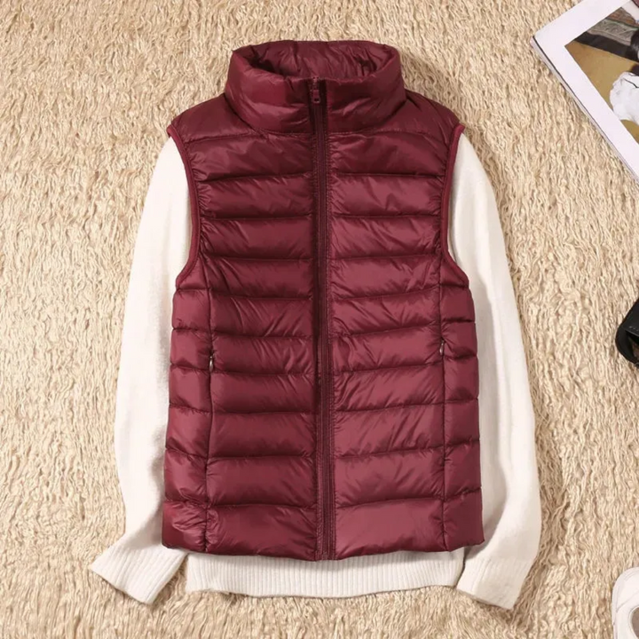 Women's sleeveless quilted puffer vest with raised collar and front zip