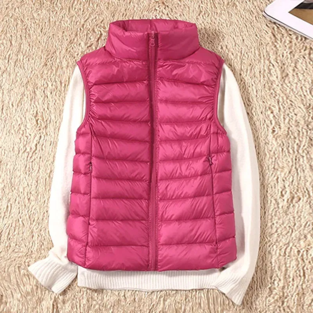 Women's sleeveless quilted puffer vest with raised collar and front zip