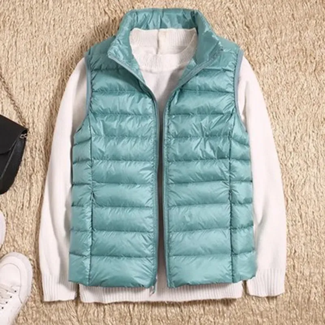 Women's sleeveless quilted puffer vest with raised collar and front zip