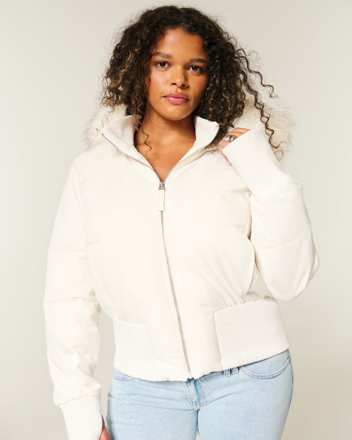 Women's quilted hooded jacket with fur-trimmed hood and ribbed cuffs