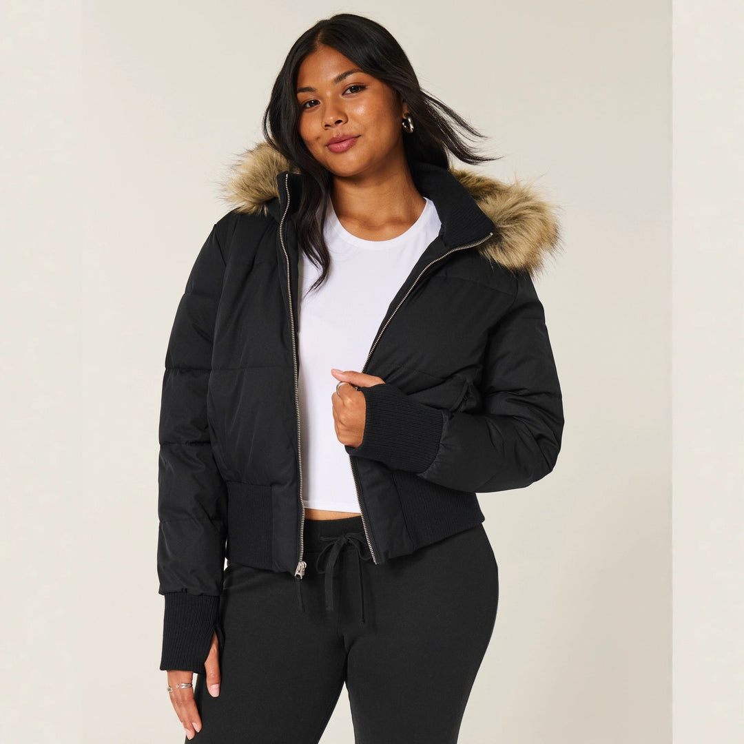 Women's quilted hooded jacket with fur-trimmed hood and ribbed cuffs
