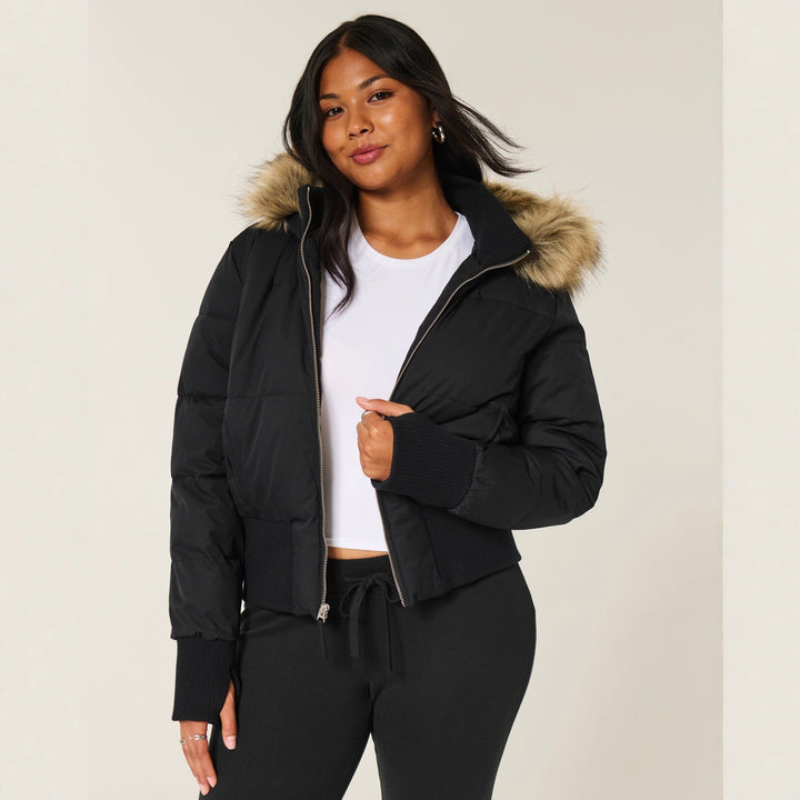 Women's quilted hooded jacket with fur-trimmed hood and ribbed cuffs