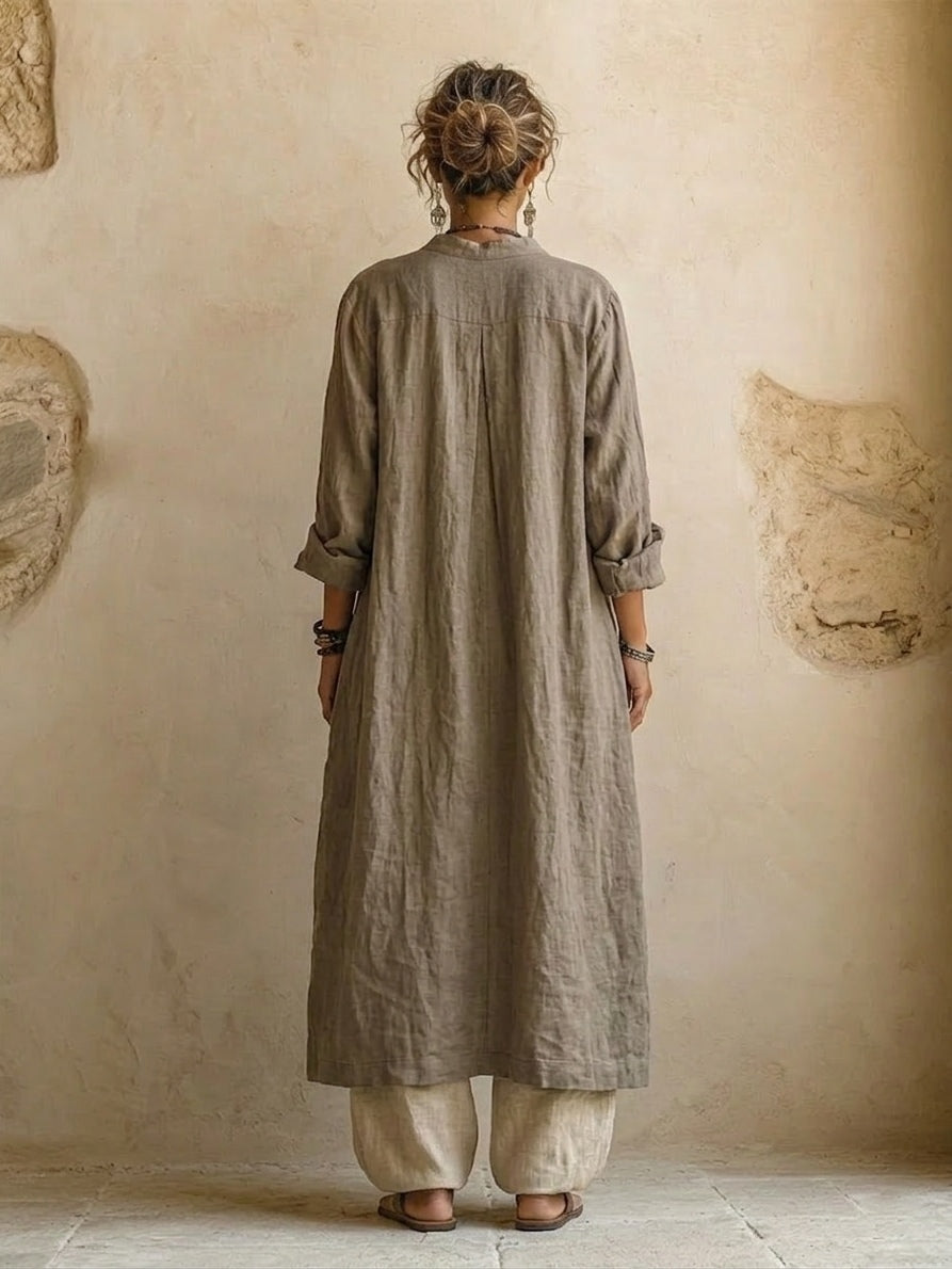 Women's three-piece set with beige button shirt, patterned vest, and wide-leg trousers