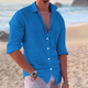 Men's long sleeve button-front shirt in white and black, shown on beach, worn open with relaxed fit.