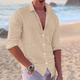 Men's long sleeve button-front shirt in white and black, shown on beach, worn open with relaxed fit.