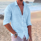 Men's long sleeve button-front shirt in white and black, shown on beach, worn open with relaxed fit.