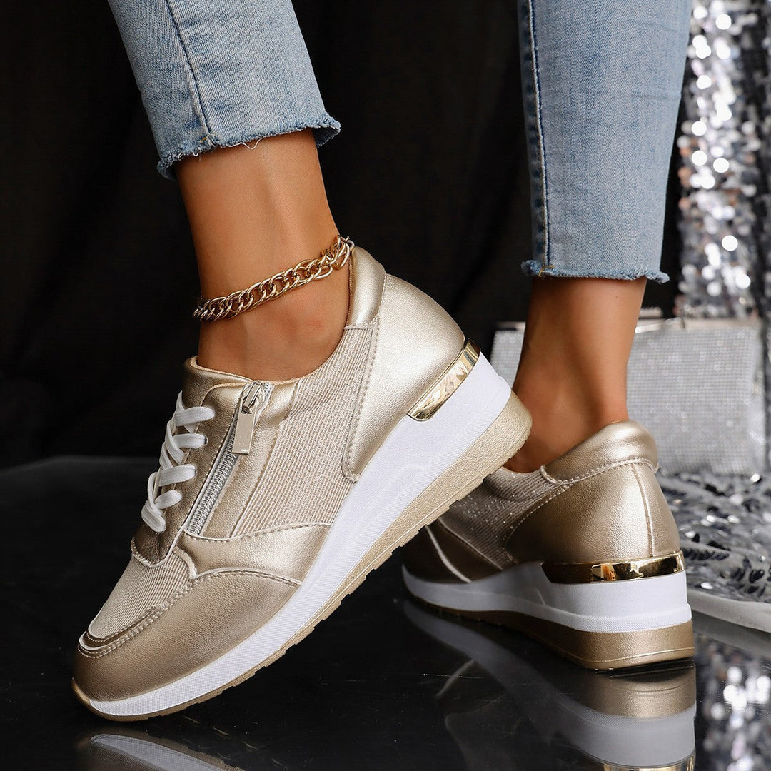 Women's silver metallic platform sneaker with lace-up front, side zip, and chunky white sole