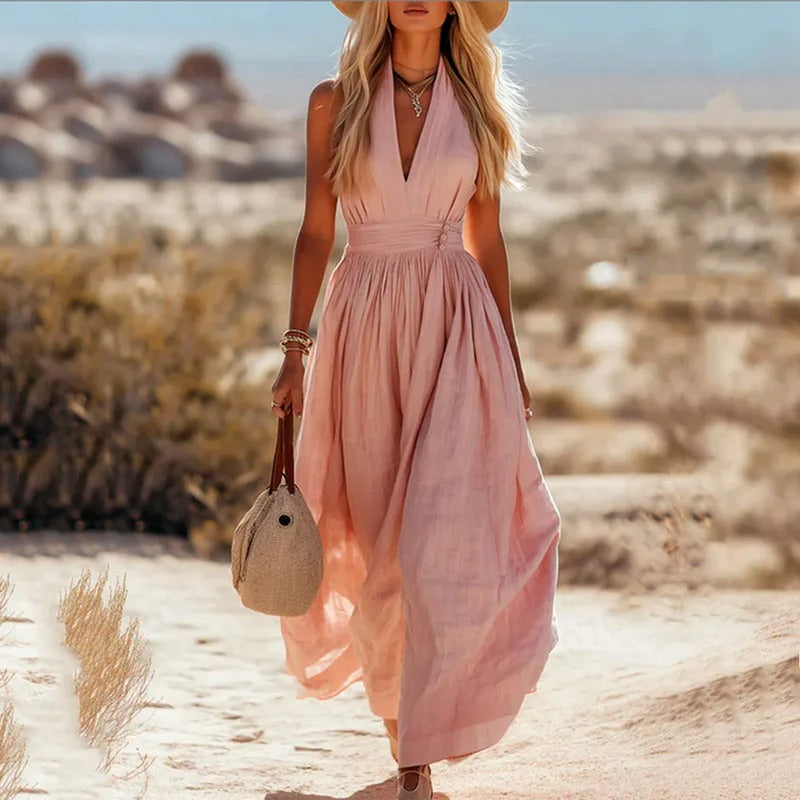 Women's halter maxi dress in brown and white with V-neck, sleeveless cut, and pleated skirt