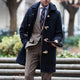 Men's hooded toggle trench coat with broad collar and multiple front pockets