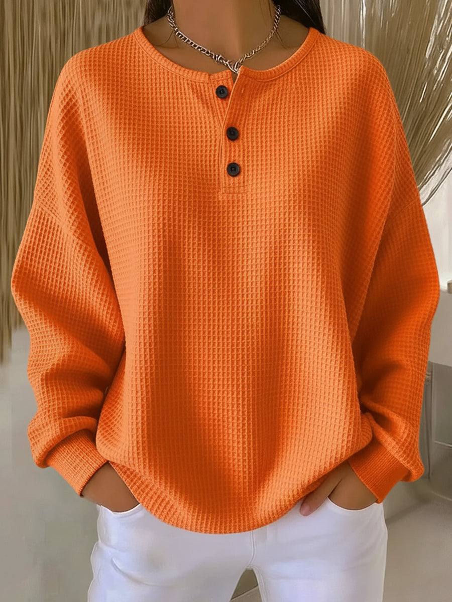 Women's long-sleeve waffle henley top with round neckline and button placket