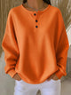 Women's long-sleeve waffle henley top with round neckline and button placket