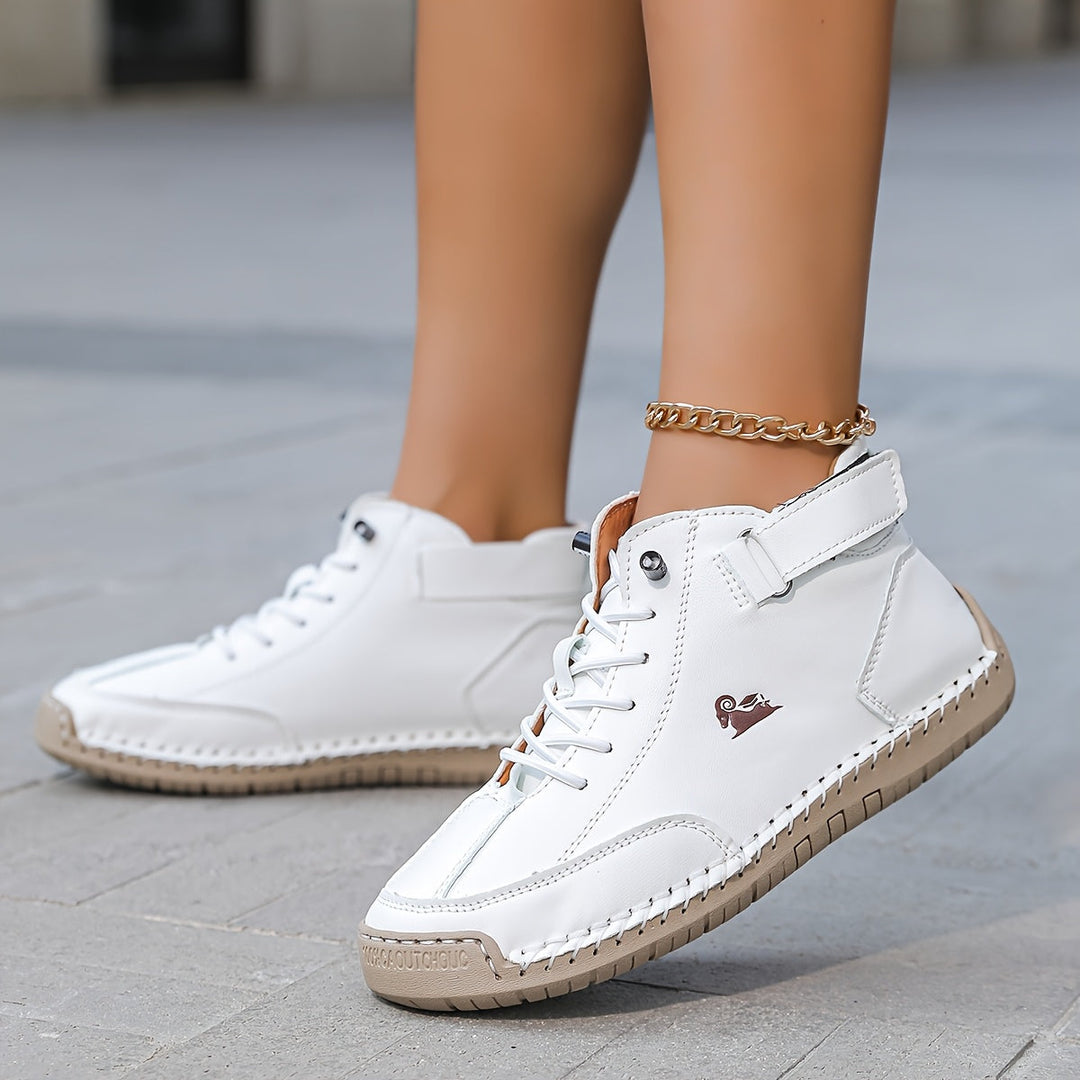 High-top lace-up sneakers with ankle straps, round toes and stitched panel detailing