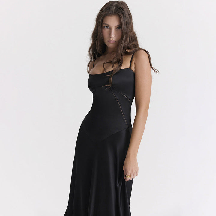 Women's black maxi dress with cowl neckline and cami straps, showing full-length floor skirt and back tie detail