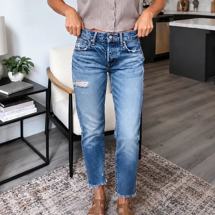 Women's blue distressed straight leg jeans with cropped frayed hems