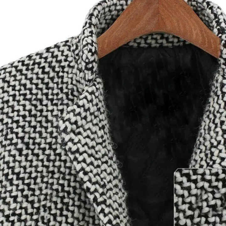Women's black and white houndstooth long coat with notched lapels and button fastening