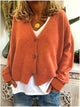 Women's long-sleeve V-neck button front cardigan layered over a white top and jeans