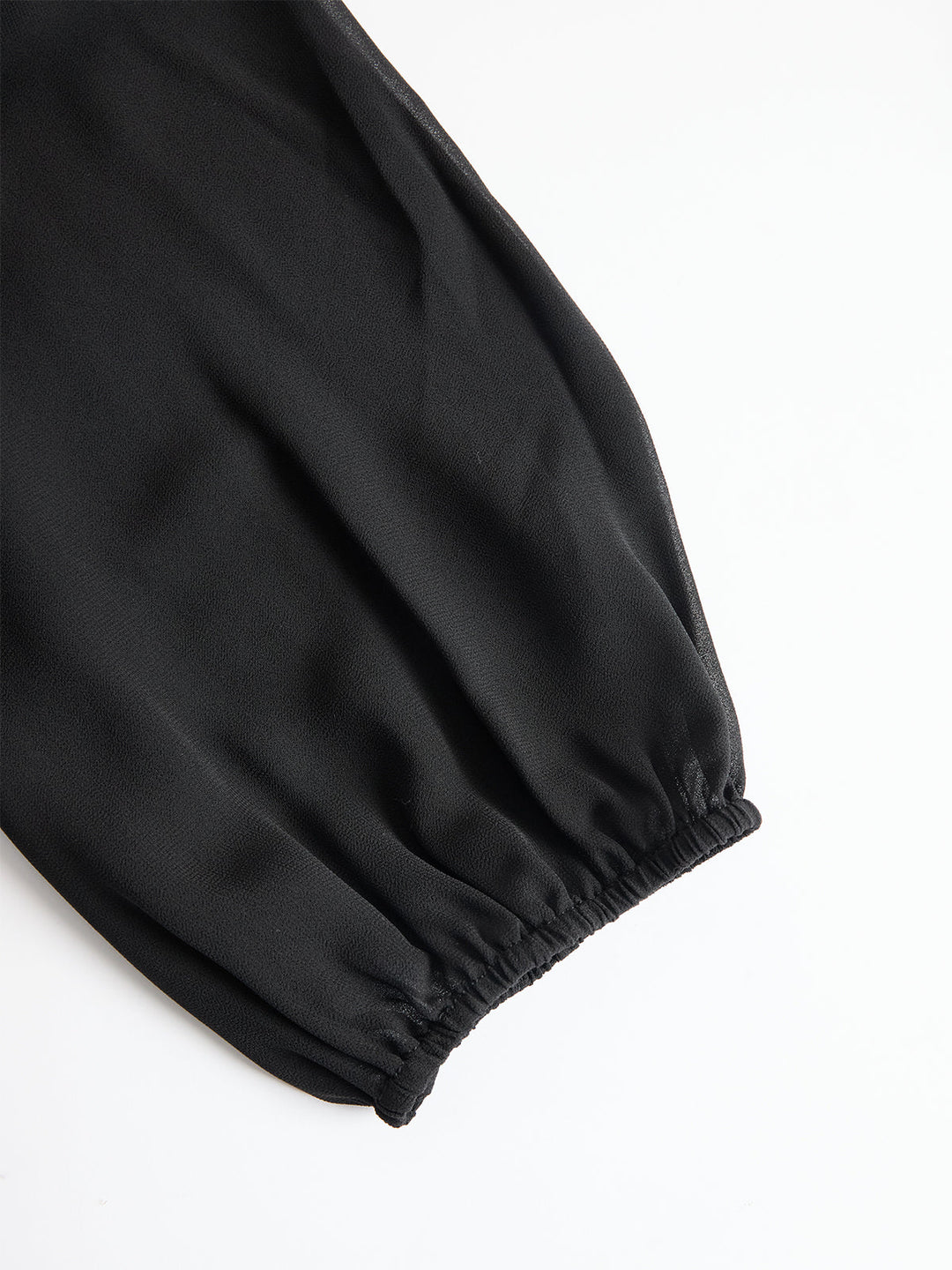 Women's three-piece set with sheer puff-sleeve top, fitted camisole and wide-leg trousers, shown in black and navy blue.