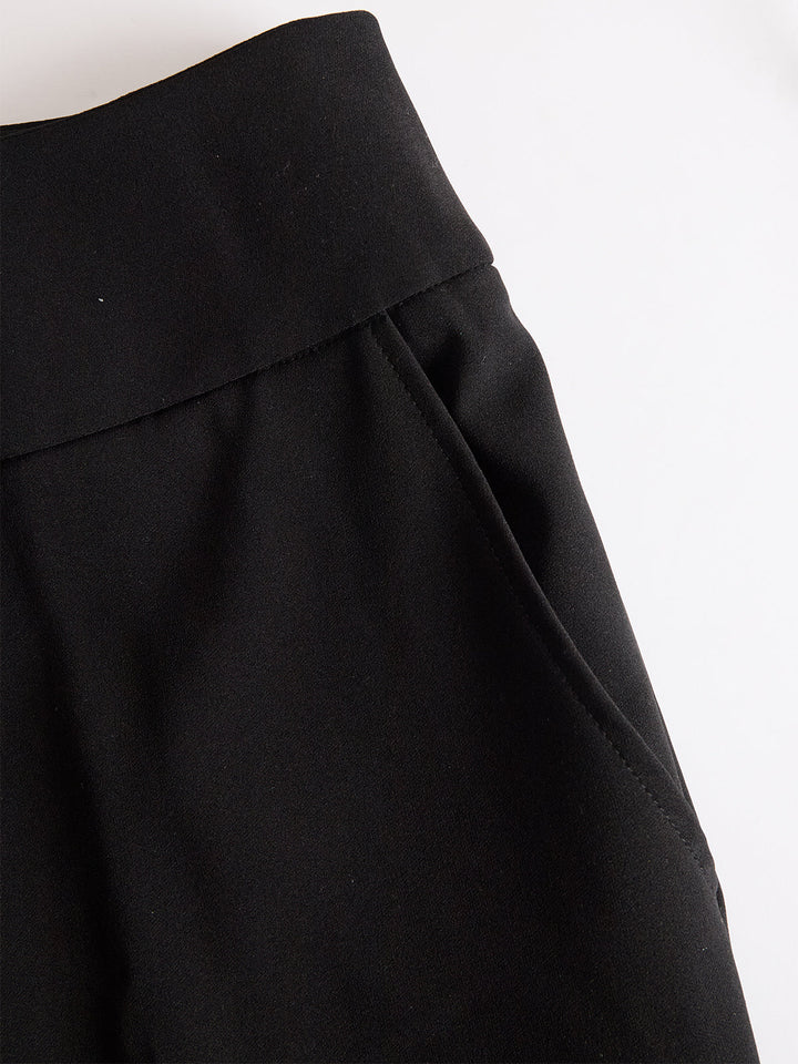 Women's three-piece set with sheer puff-sleeve top, fitted camisole and wide-leg trousers, shown in black and navy blue.
