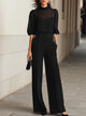 Women's three-piece set with sheer puff-sleeve top, fitted camisole and wide-leg trousers, shown in black and navy blue.