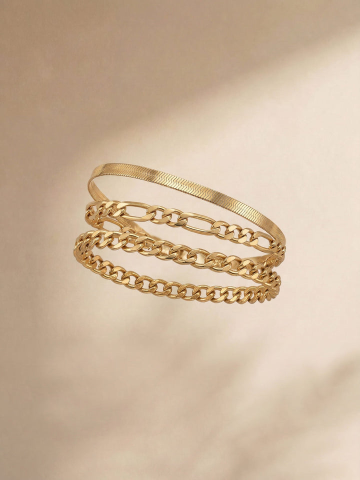 Three delicate chain bracelets in mixed link styles, stackable