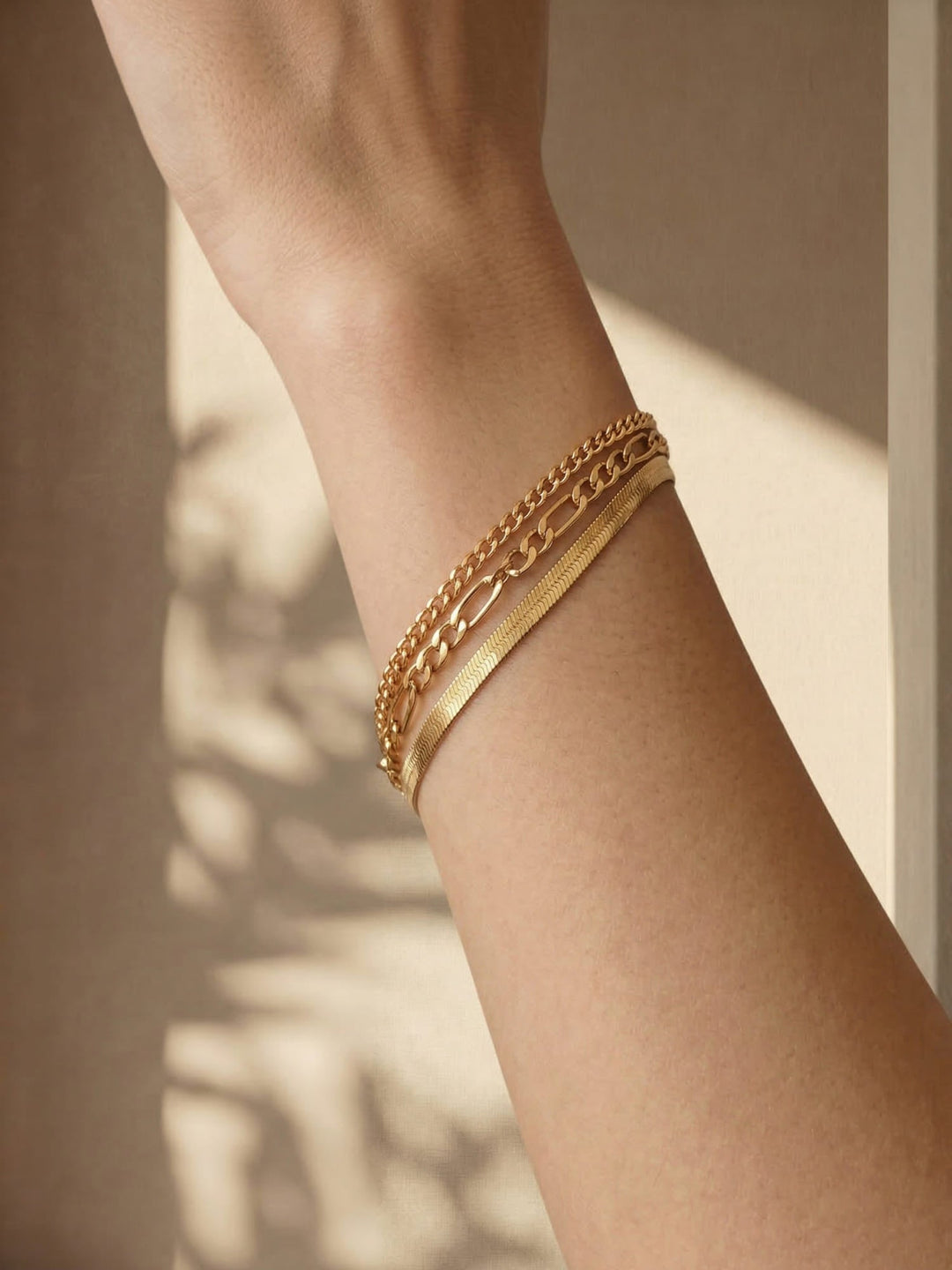 Three delicate chain bracelets in mixed link styles, stackable