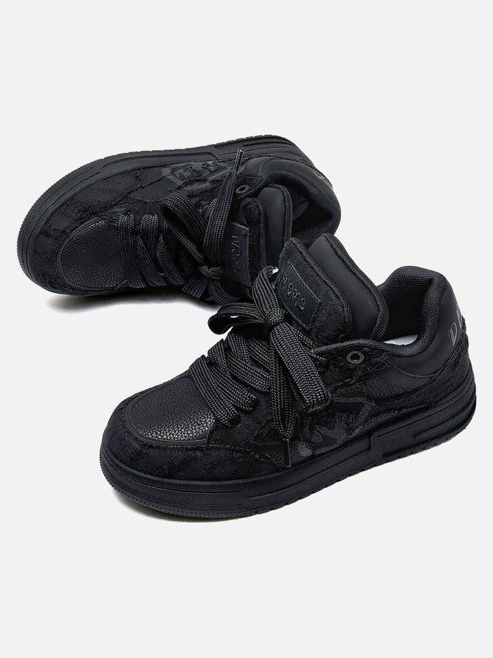 Black unisex high top trainers with lace-up fronts and camouflage panels