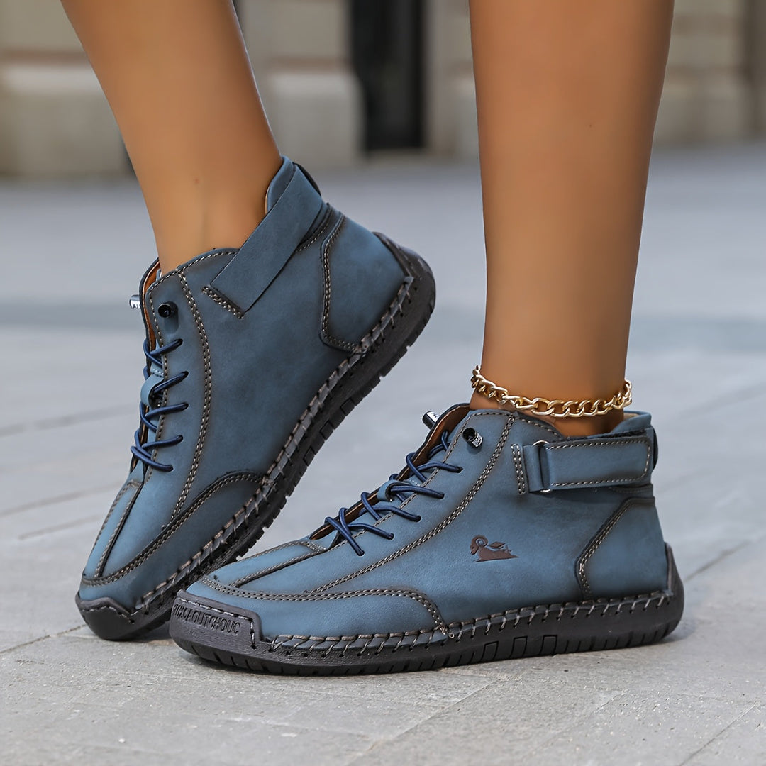 High-top lace-up sneakers with ankle straps, round toes and stitched panel detailing