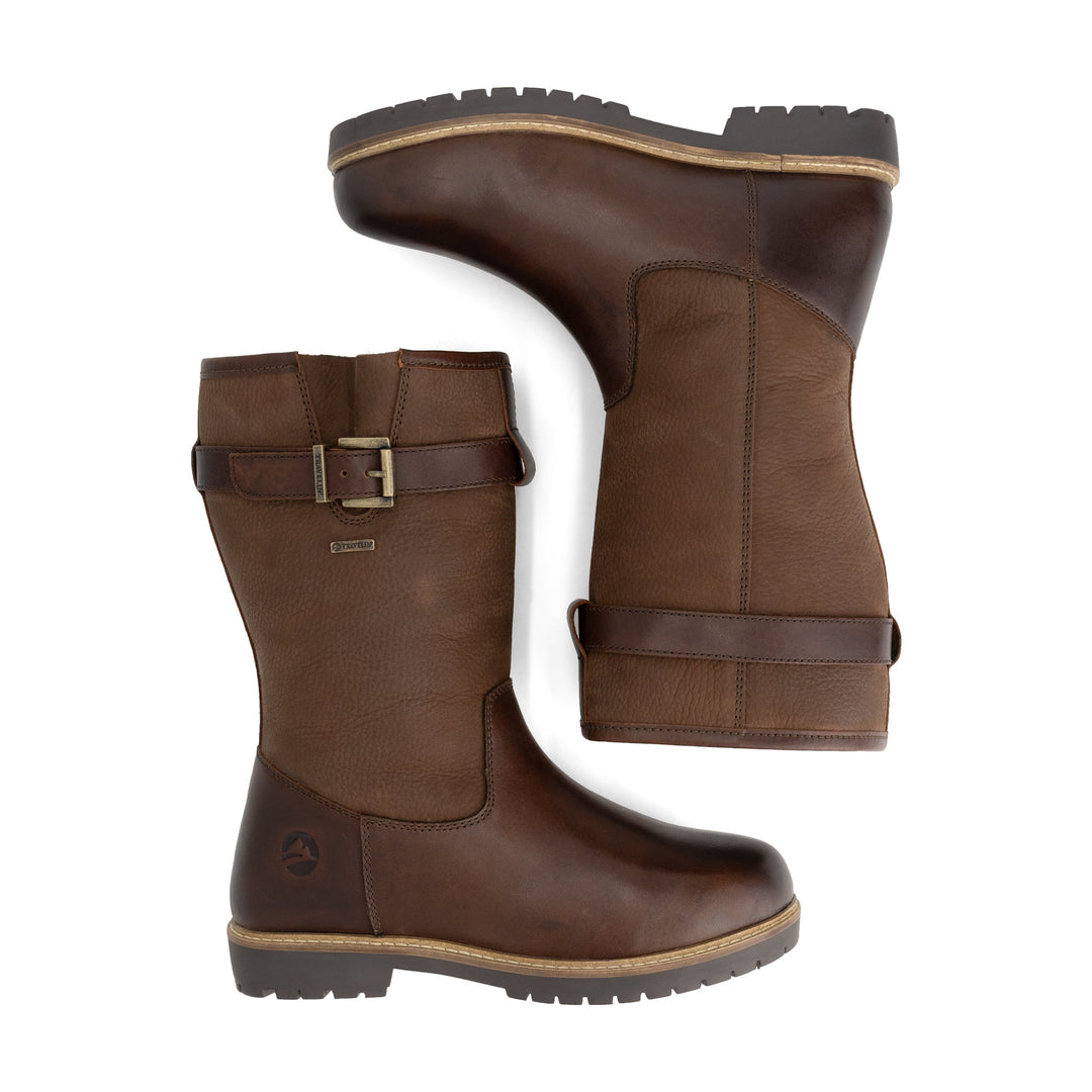 Brown tall outdoor boots with buckle straps and flat lug soles