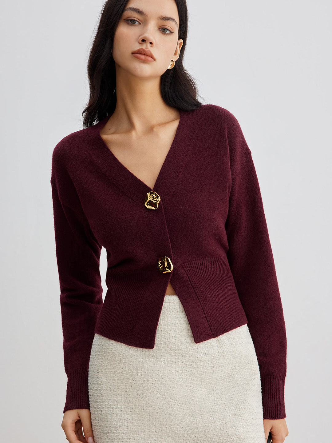 Women's short plain V-neck cardigan with long sleeves and decorative button front