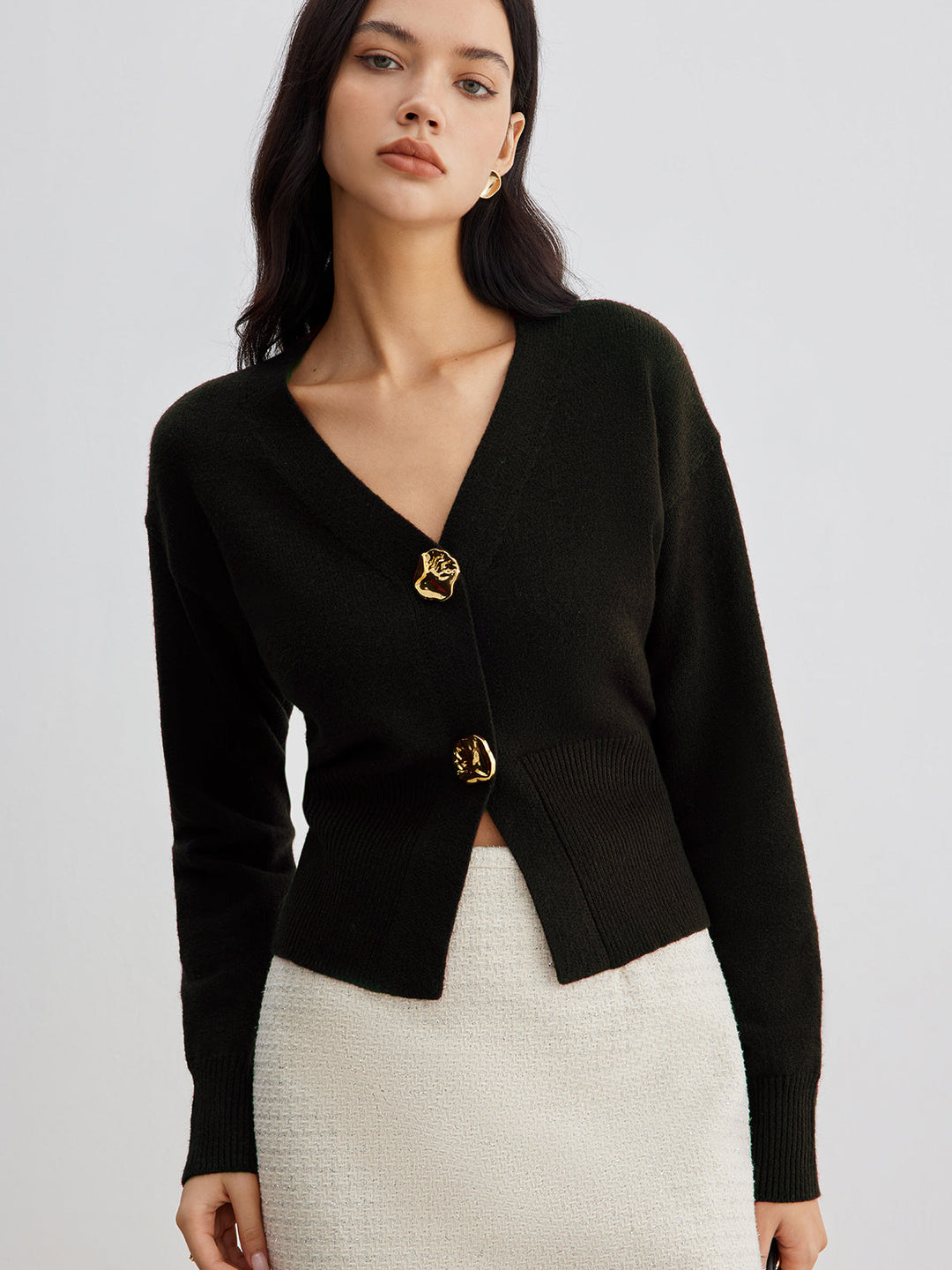 Women's short plain V-neck cardigan with long sleeves and decorative button front