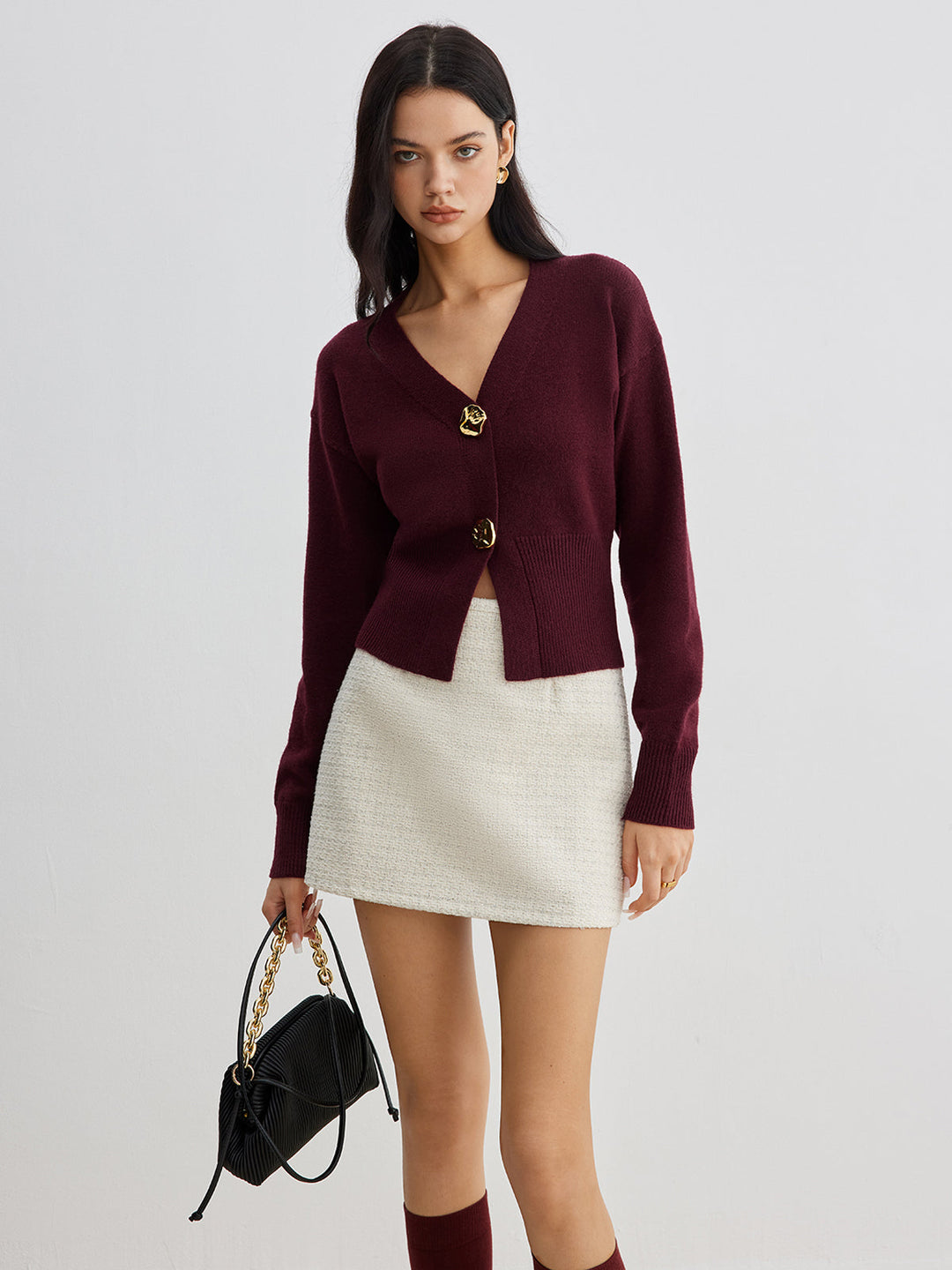 Women's short plain V-neck cardigan with long sleeves and decorative button front