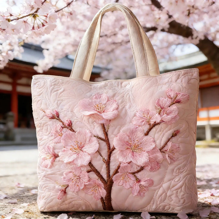 Women's quilted tote bag with illustrated floral and animal designs
