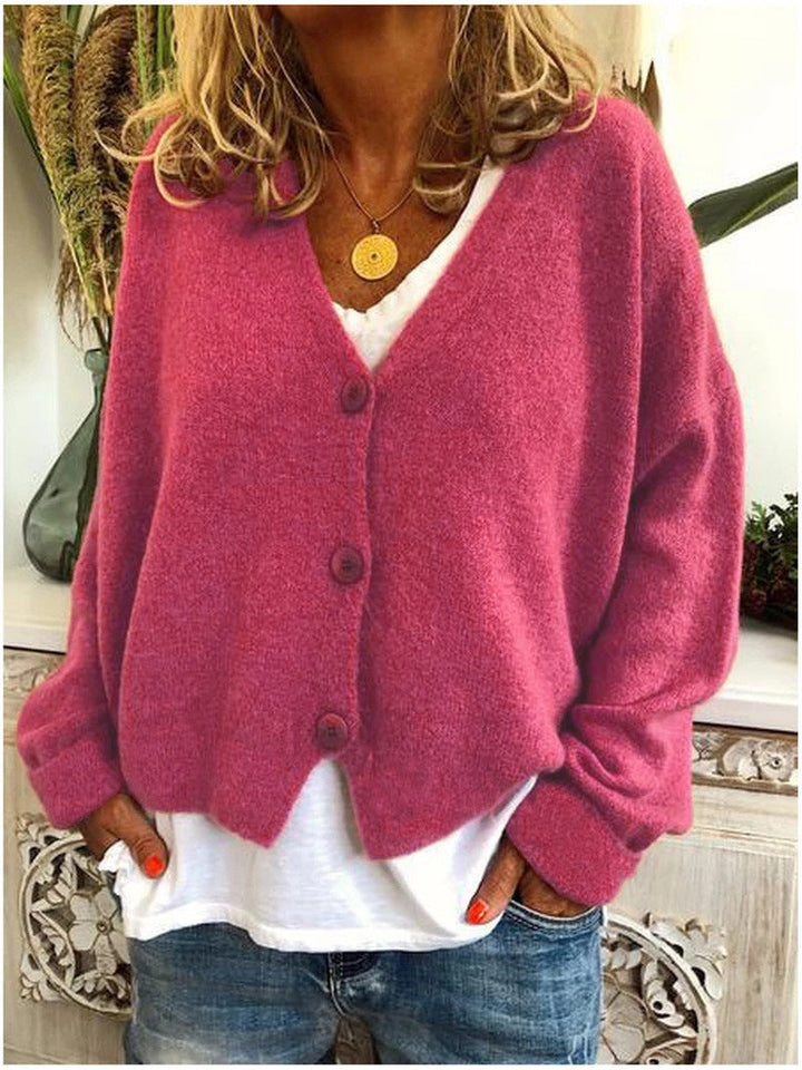 Women's long-sleeve V-neck button front cardigan layered over a white top and jeans
