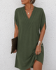 Women's wrap dress with deep V-neckline, short sleeves, and asymmetric hemline in green and blue.