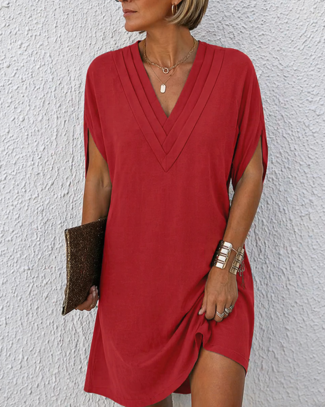 Women's wrap dress with deep V-neckline, short sleeves, and asymmetric hemline in green and blue.
