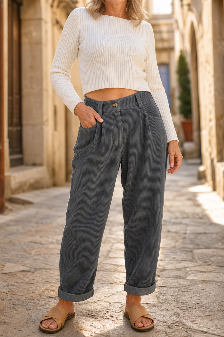 Women's high-waisted textured wide-leg trousers with pleated front, pockets and rolled cuffs