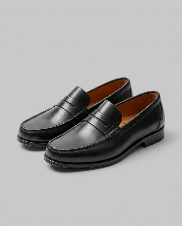 Men's slip-on penny loafers with moc-toe stitching and low heel