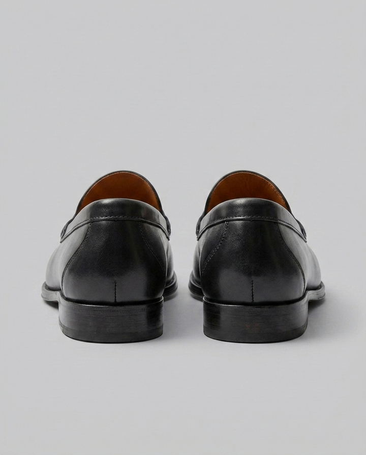 Men's slip-on penny loafers with moc-toe stitching and low heel
