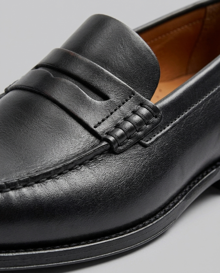 Men's slip-on penny loafers with moc-toe stitching and low heel
