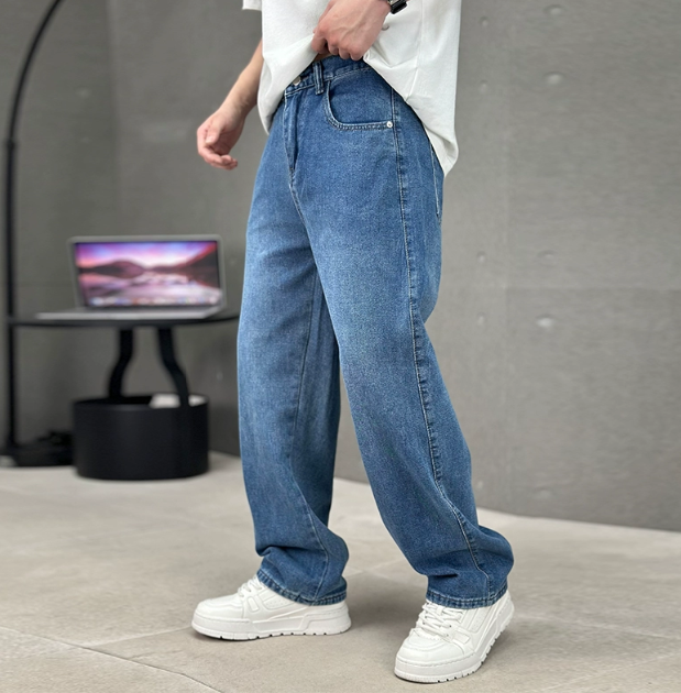 Men's relaxed straight-leg denim jeans shown with white trainers