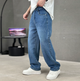 Men's relaxed straight-leg denim jeans shown with white trainers