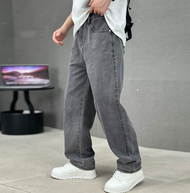 Men's relaxed straight-leg denim jeans shown with white trainers